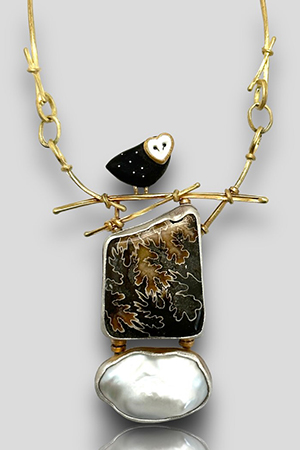 Carolyn Morris Bach Necklace with an Ebony owl sitting on a gold branch with ammonite and pearl